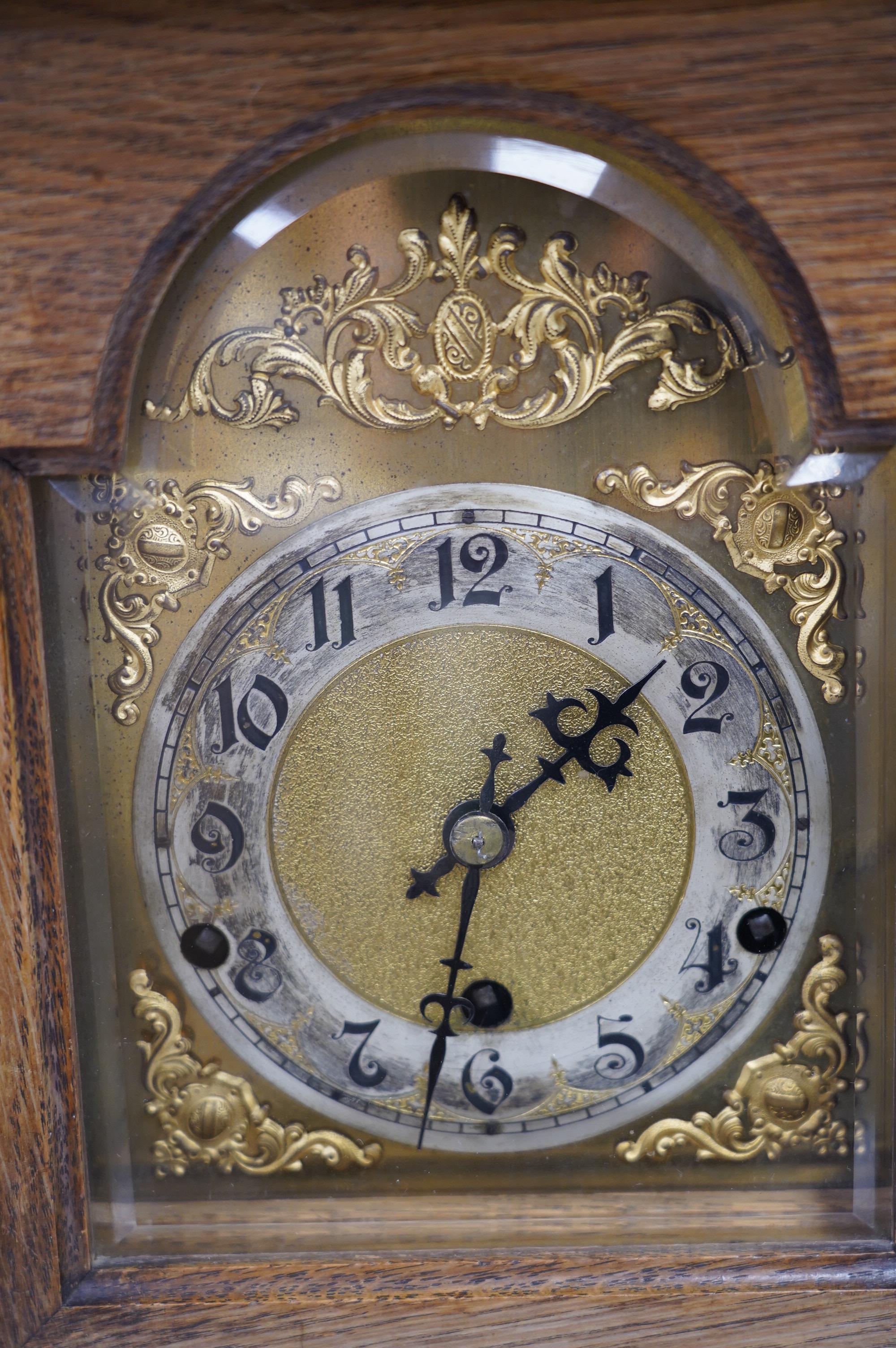 An oak bracket clock with a German three train movement, chiming on five gongs, 47cm high. Condition - fair to good, some wear to chapter ring, etc.